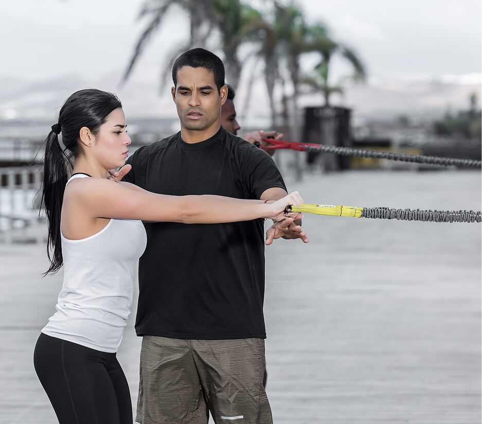trainer-helping-woman-with-resistance-band-exercis-2025-03-09-16-24-25-utc (1)